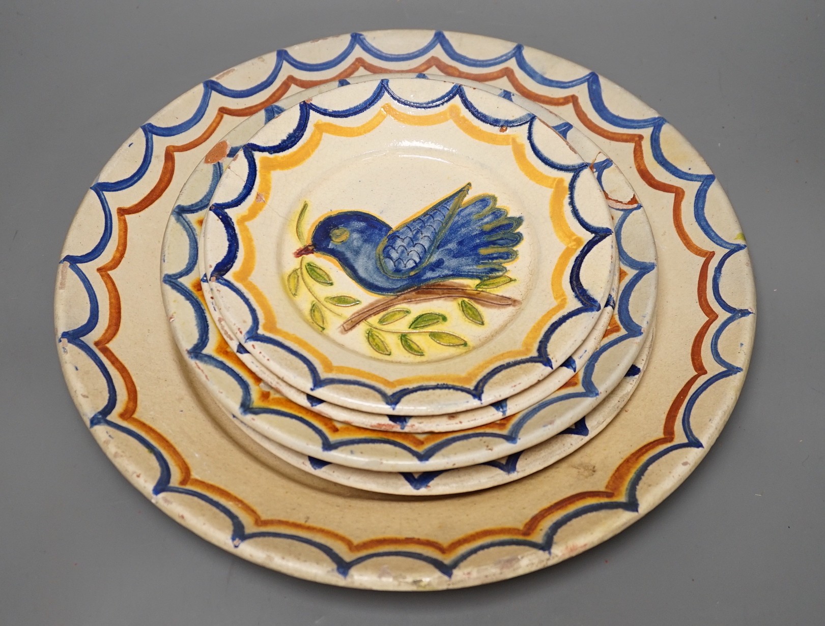 Five Portuguese provincial pottery plates, largest 35 cms diameter